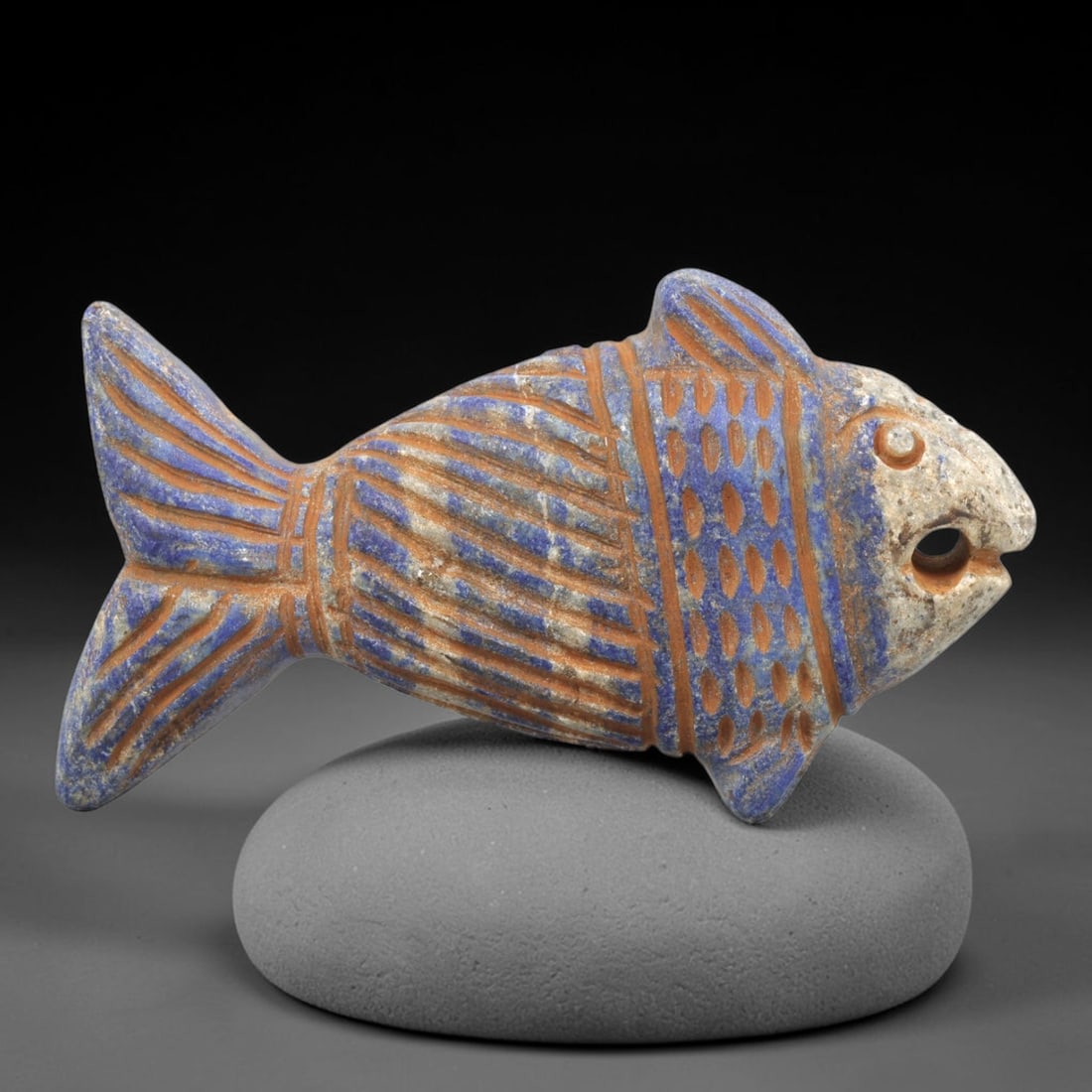 Near Eastern Lapis Lazuli Plaque - Tribal Art Fish Amulet Figurine, 81ZY: Carved from solid lapis lazuli, this Near Eastern tribal art piece is shaped as a stylized fish amulet figurine, executed with detailed tribal craftsmanship. The fish form is rendered with mixed incis