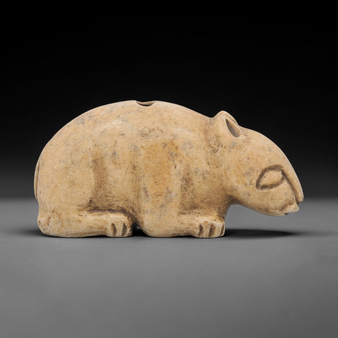 Ancient Stone Rodent Amulet - Near Eastern Zoomorphic Figurine, 14WJ: Carved from a fine-grained, pale beige stone, this artifact takes the form of a stylized zoomorphic rodent figure, rendered in a naturalistic crouching posture. The creature is depicted with a rounded