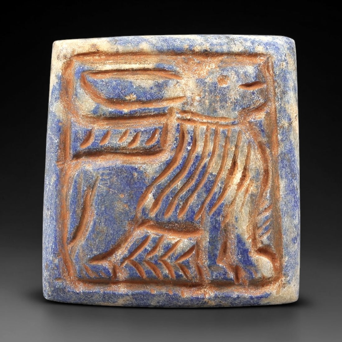 Near Eastern Lapis Lazuli Plaque - Tribal Art Feline Relief, 51BG: Carved from lapis lazuli, this square plaque features a relief depiction of a stylized feline figure, rendered with incised linear detailing characteristic of Near Eastern tribal artistic traditions.