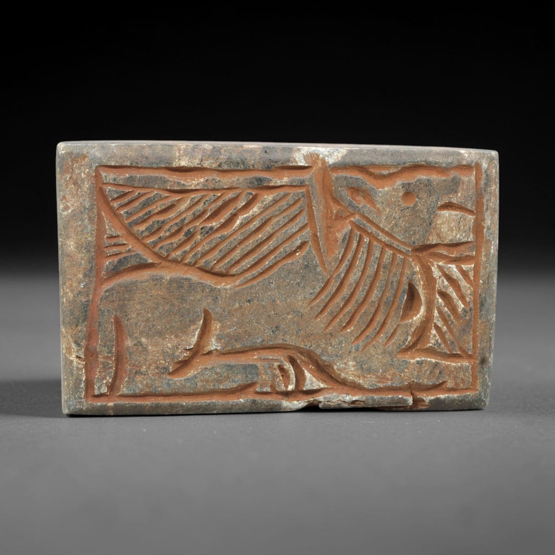 Near Eastern Schist Plaque - Tribal Art Feline Figure Relief, 51ZY: Carved from schist, this rectangular plaque features a deeply incised relief depiction of a stylized feline figure, rendered in a geometric Near Eastern tribal idiom. The animal is defined by linear i