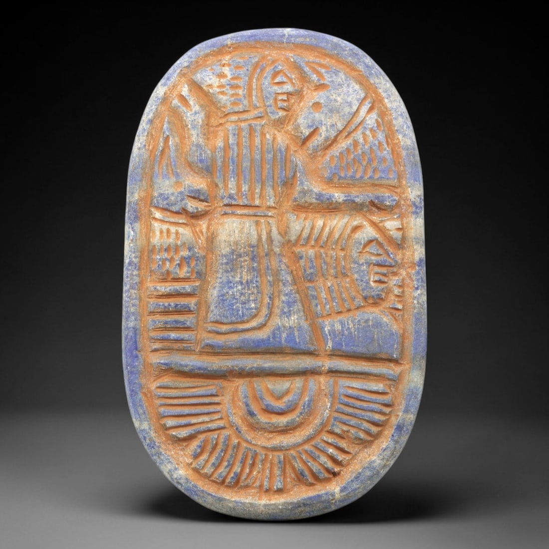 Near Eastern Lapis Lazuli Plaque - Tribal Art Deity & Animal Relief, 37ZA: Carved from rich lapis lazuli, this oval plaque features an 8.1x5cm (3.19x1.97in) relief composition depicting a central stylized deity figure (with sun-disk/headdress) standing above an animal motif,