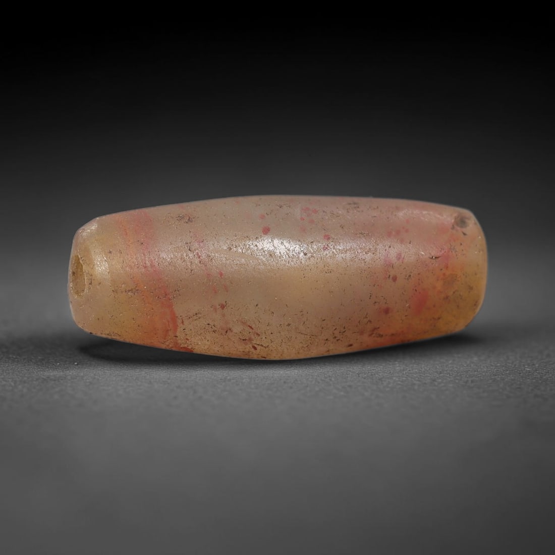 Ancient Agate Bead - Silk Road Cylinder Amulet, 85BD: Carved from translucent agate, the bead features a smooth cylindrical barrel form with a polished surface that highlights the stone's pale milky base, densely speckled with fine red mineral inclusions