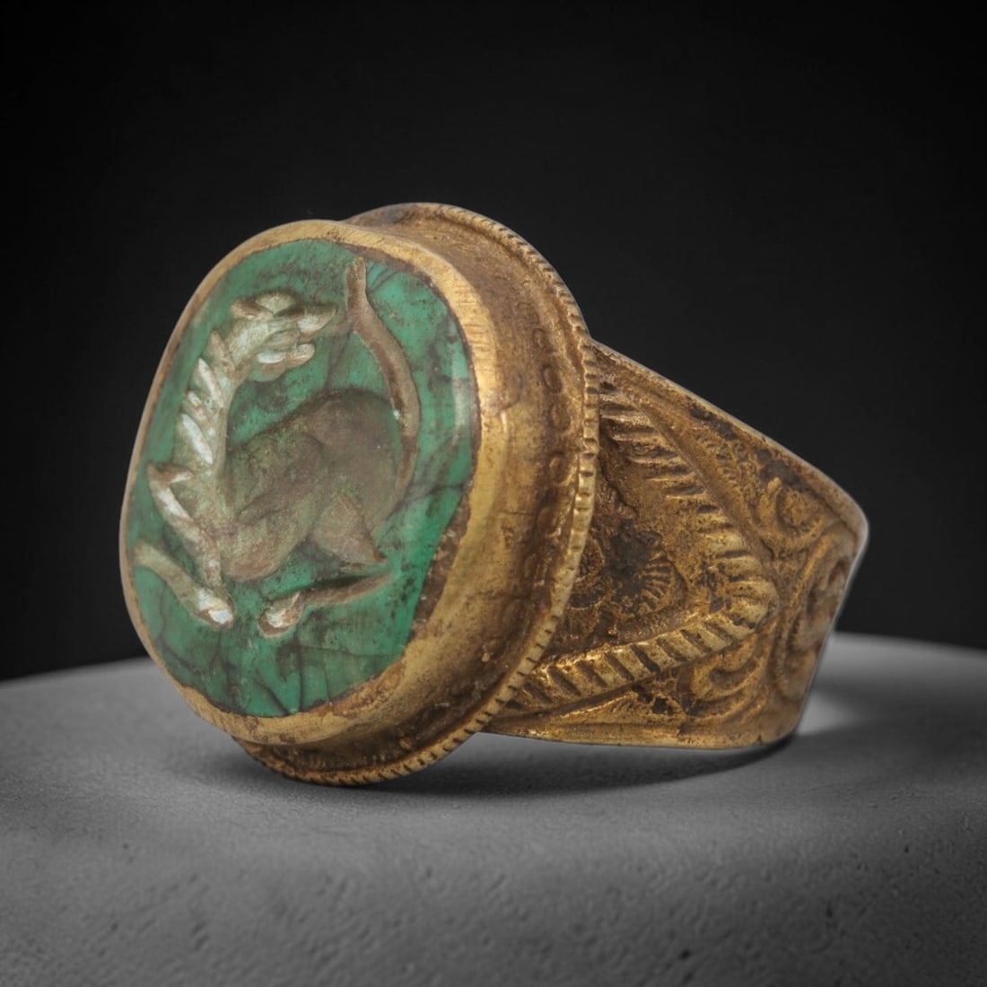 Antique Qajar Dynasty Turquoise Intaglio Ring - Size 7 US, 85ZX: Crafted from gilt brass with a rounded bezel, this ring features a carved turquoise intaglio stone at its center, incised with a stylized quadruped motif characteristic of Qajar-era Persian symbolic c