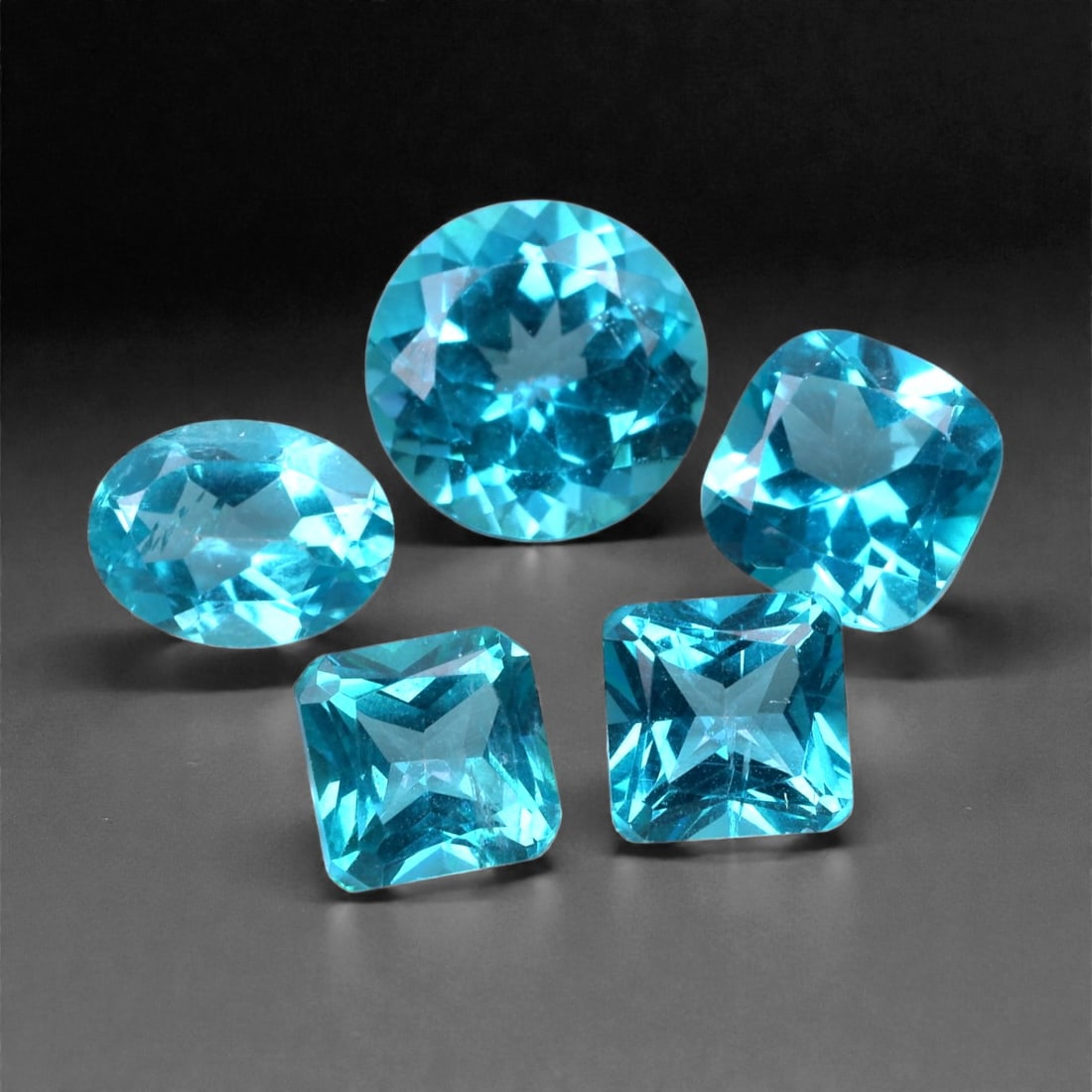 9.54 Carats Paraiba Blue Topaz Selection - Natural Brazilian Stones, 6-8mm, 94XH: This vivid selection of topaz dazzles in a rare and highly sought-after Paraiba blue hue-an electric, neon turquoise tone reminiscent of tropical waters. With exceptional clarity and precision facetin