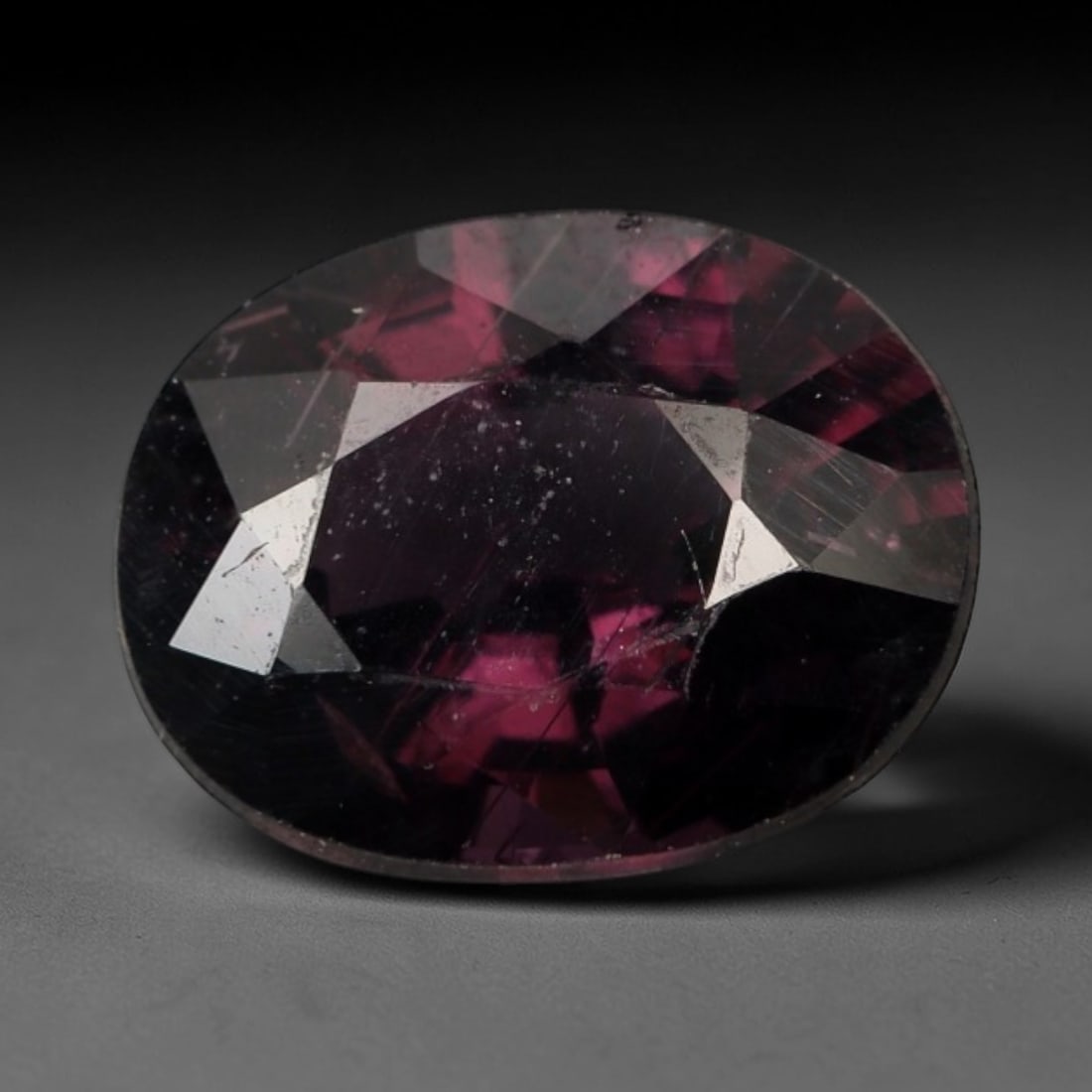 1.146 Carats Certified Dark Purple Orangy Spinel - Natural Gemstone, LZ268: This singular oval mixed-cut spinel captivates with a deep purple hue infused with warm, orangy undertones, creating a rich, velvety appearance that shifts subtly under light. The stone's faceting enh