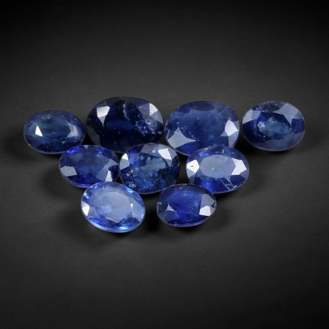 5.44 Carats Blue Sapphire - Oval Faceted Gemstone, 87WE: Oval faceted blue sapphire gemstone, crafted from sapphire material. The stone exhibits a rich, deep blue hue with subtle tonal variations and natural internal inclusions characteristic of genuine sap