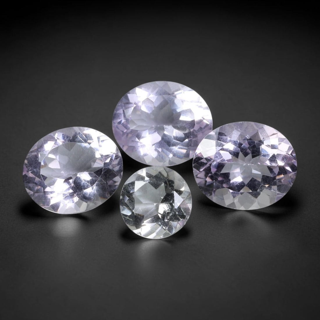 23.81 Carats Natural Amethyst - Oval Faceted Gemstone, 85WE: Oval faceted amethyst gemstone, crafted from natural amethyst material. The stone exhibits a soft, pale lavender to lilac hue with exceptional clarity and brilliance, showcasing the characteristic tra