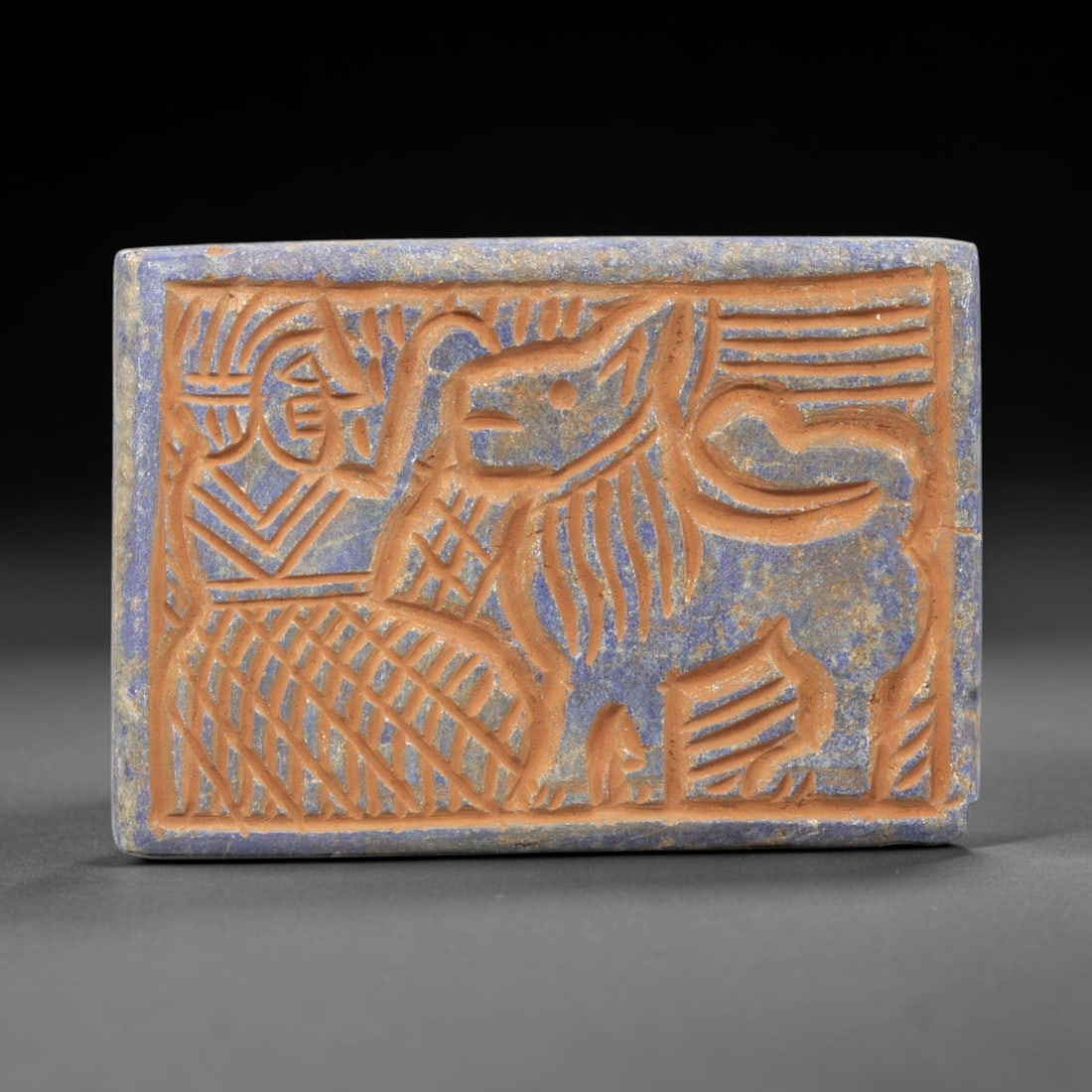 Near Eastern Lapis Lazuli Plaque - Tribal Art Figure & Animal Relief, 45ZY: Carved from natural lapis lazuli stone, this Near Eastern tribal art plaque relief features a hand-carved composition of a stylized human figure alongside a large animal motif, executed with incised l