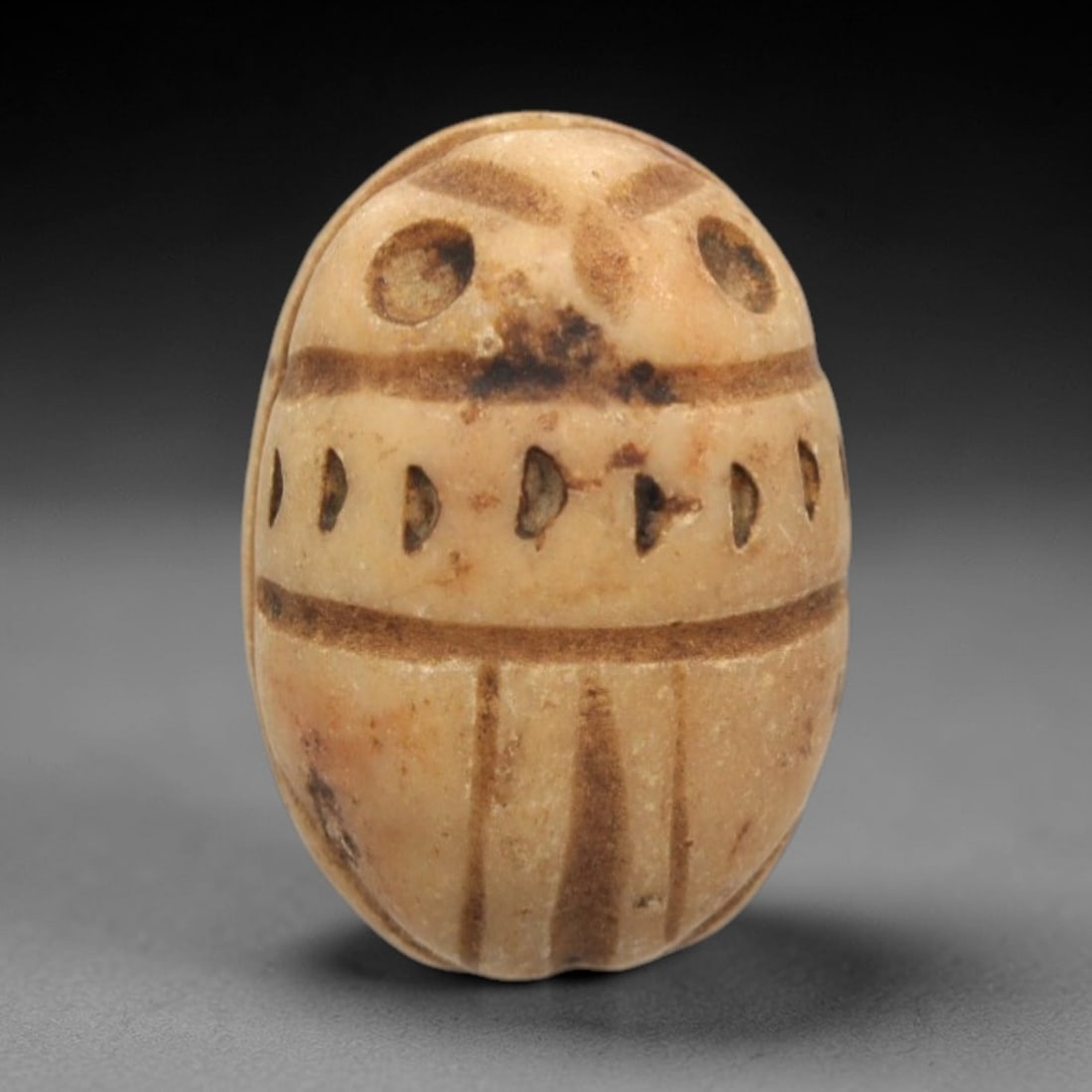 Ancient Steatite Scarab Stamp Seal - Near Eastern Horse Figure, 36ZS: Carved from pale beige steatite with dark brown incised patination, this Near Eastern scarab stamp seal features a dorsal scarab pattern with linear elytra segments and decorative perforations, while