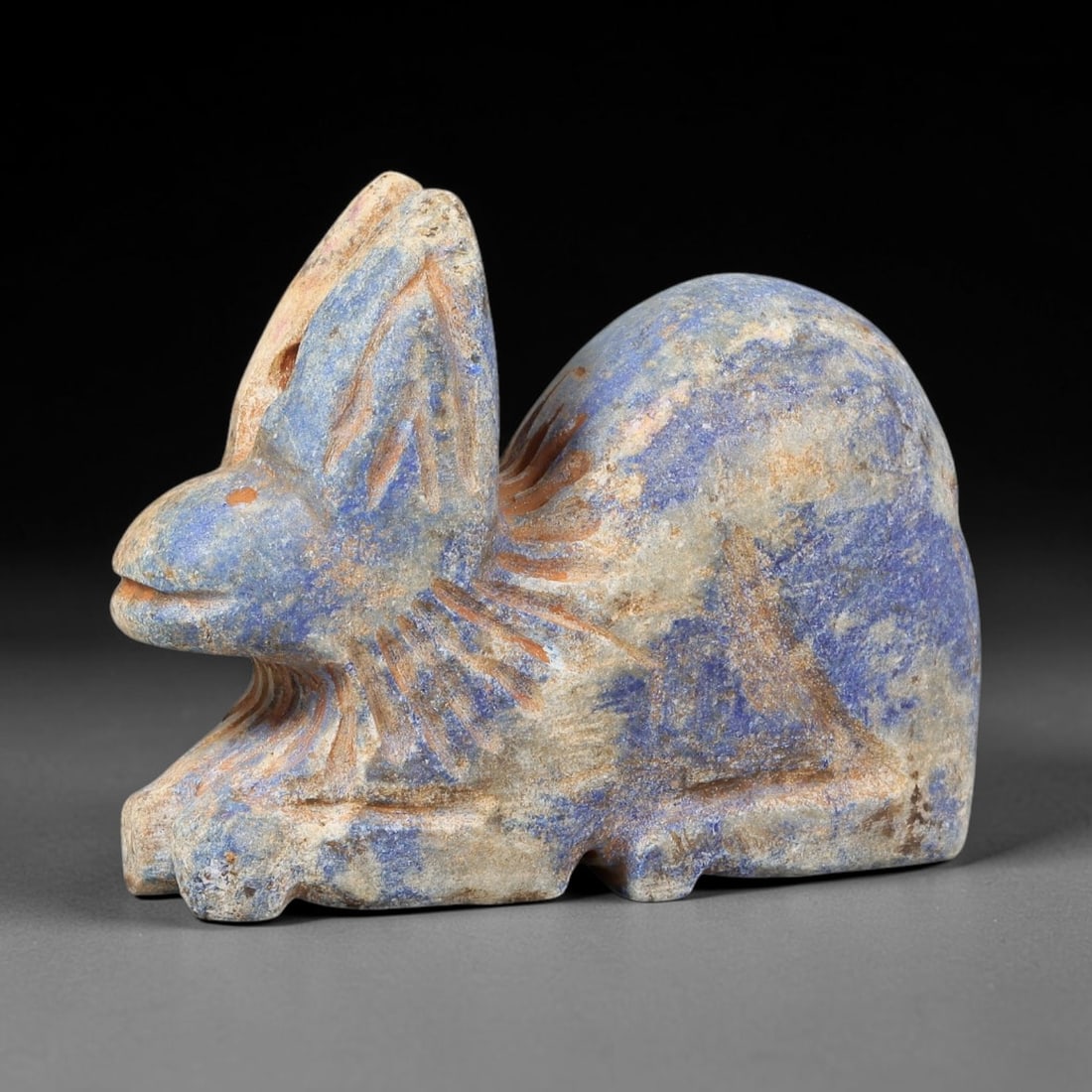 Near Eastern Lapis Lazuli Plaque - Tribal Art Zoomorphic Feline Figurine, 63BF: Carved from solid lapis lazuli, this Near Eastern tribal art piece is shaped as a stylized zoomorphic feline figurine, executed with detailed tribal craftsmanship. The feline is rendered in a crouched