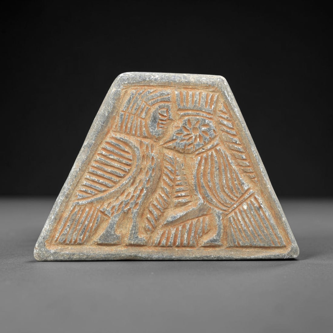 Near Eastern Schist Plaque - Tribal Art Two Figure Relief, 6ZA: Carved from solid schist, this triangular plaque features a deeply incised relief with two stylized anthropomorphic figures, executed with precise linear detailing characteristic of Near Eastern triba