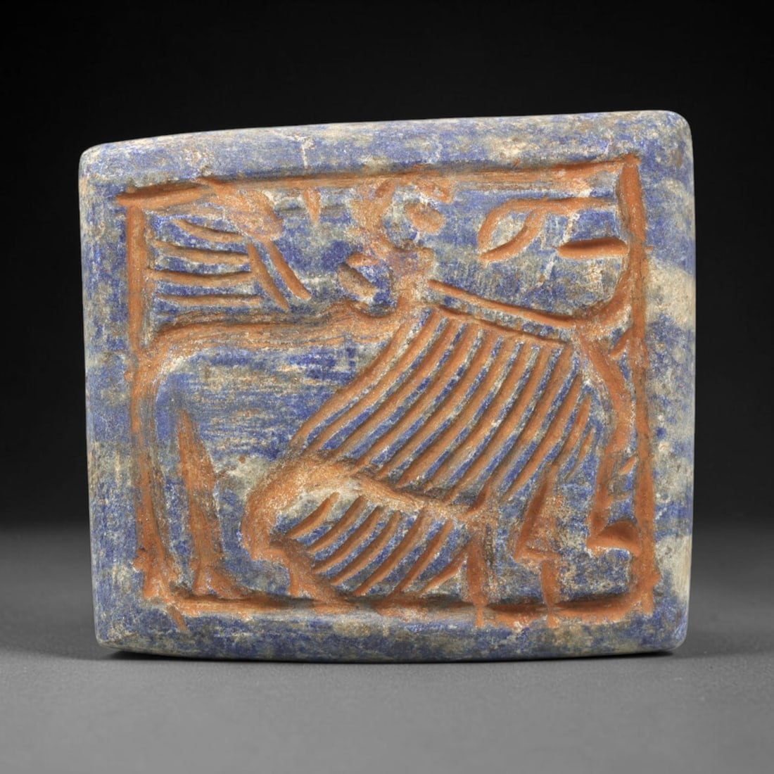 Near Eastern Lapis Lazuli Plaque - Tribal Art Animal Relief, 46ZY: Carved from natural lapis lazuli stone, this Near Eastern tribal art plaque relief features a hand-carved depiction of a stylized animal motif, executed with incised linear techniques that define the