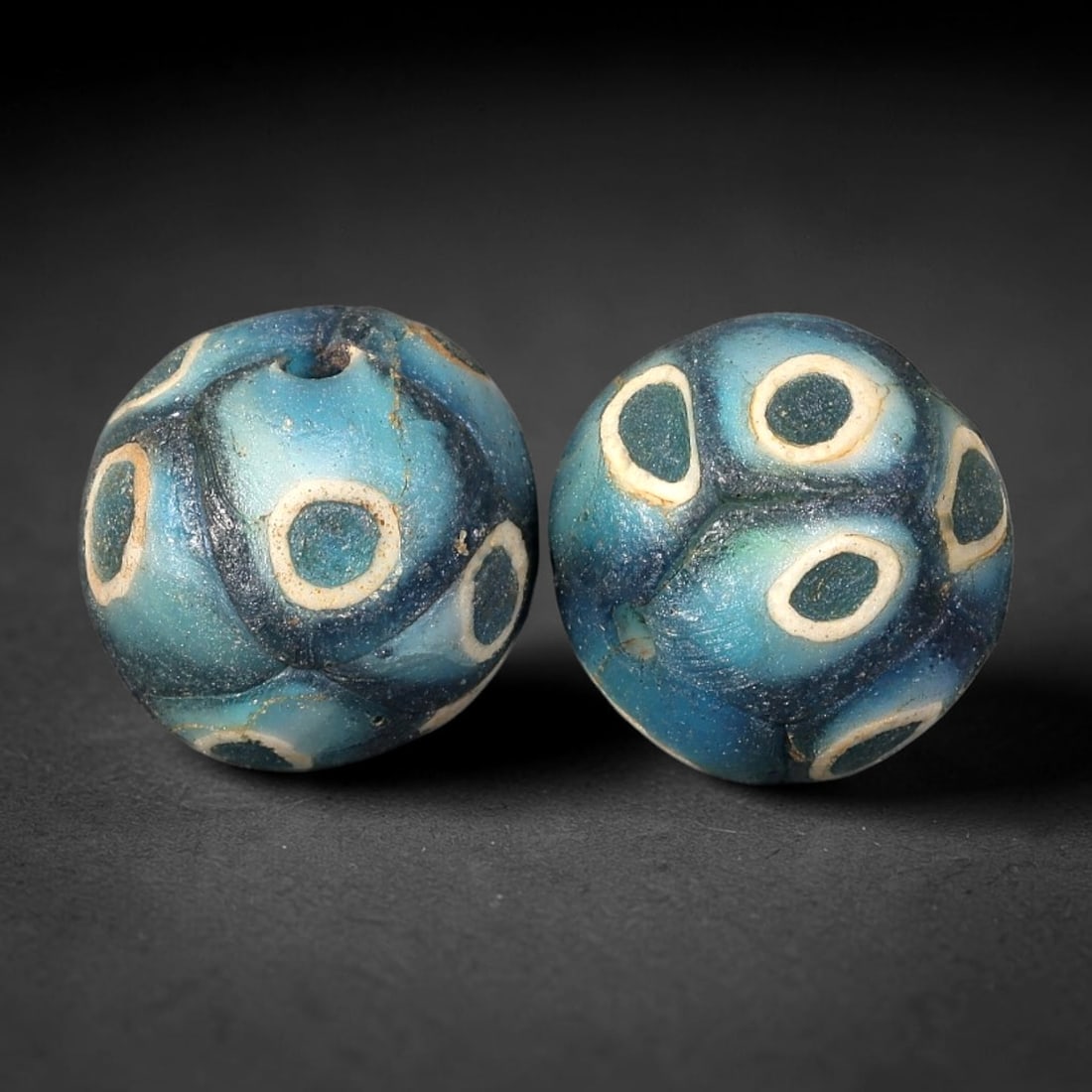 Old Glass Eye Beads - Phoenician Style Spherical Beads, 82BG: Set of two spherical old glass eye beads, crafted from layered colored glass with distinct concentric eye motifs across each surface. Each bead features raised dark blue central eyes set within white 