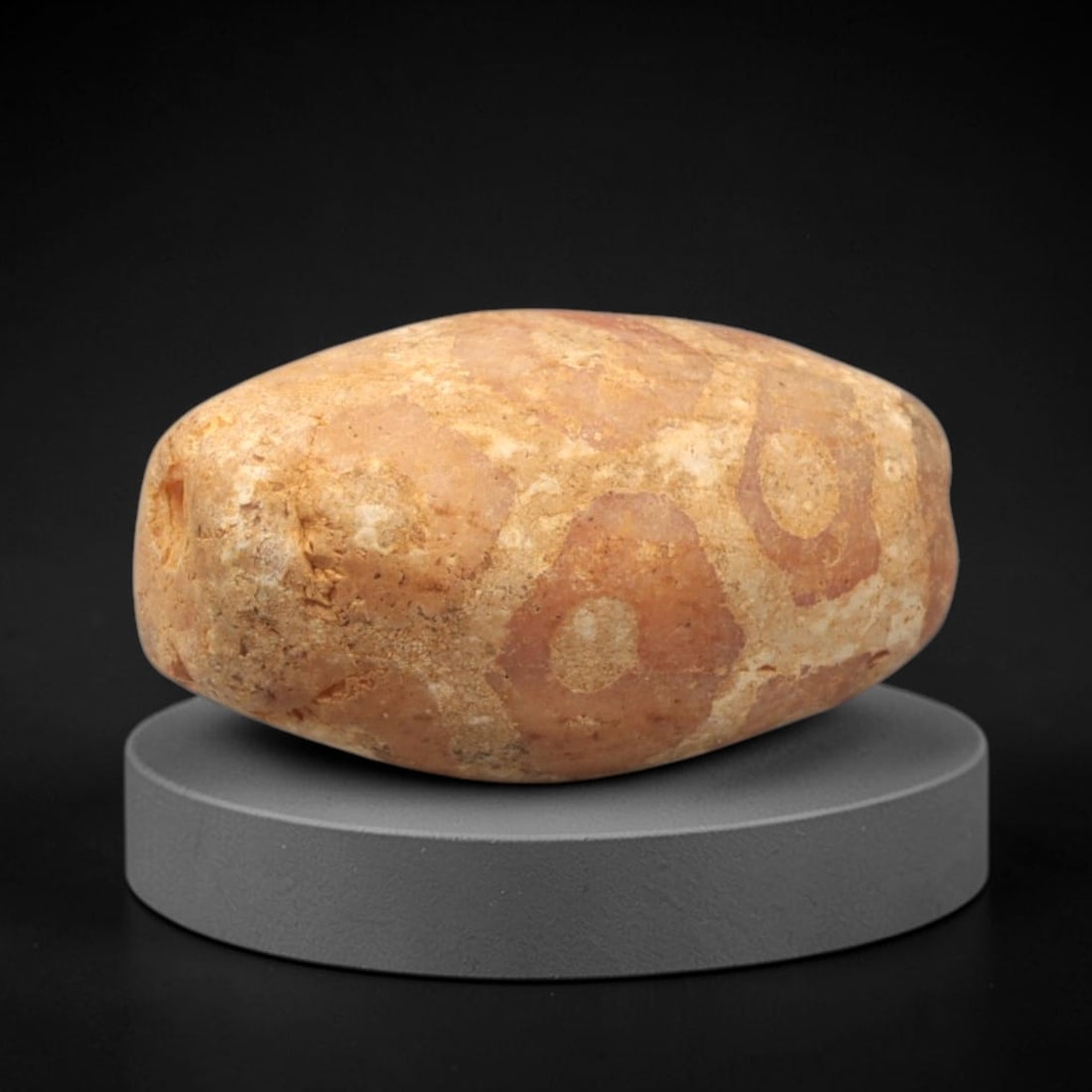 Ancient Carnelian Etched Bead - Gandhara Single Amulet, 42XY: A single large barrel-shaped bead crafted from carnelian, decorated with etched circular and geometric motifs in a pale white/cream pigment, characteristic of Gandharan decorative traditions. The bead