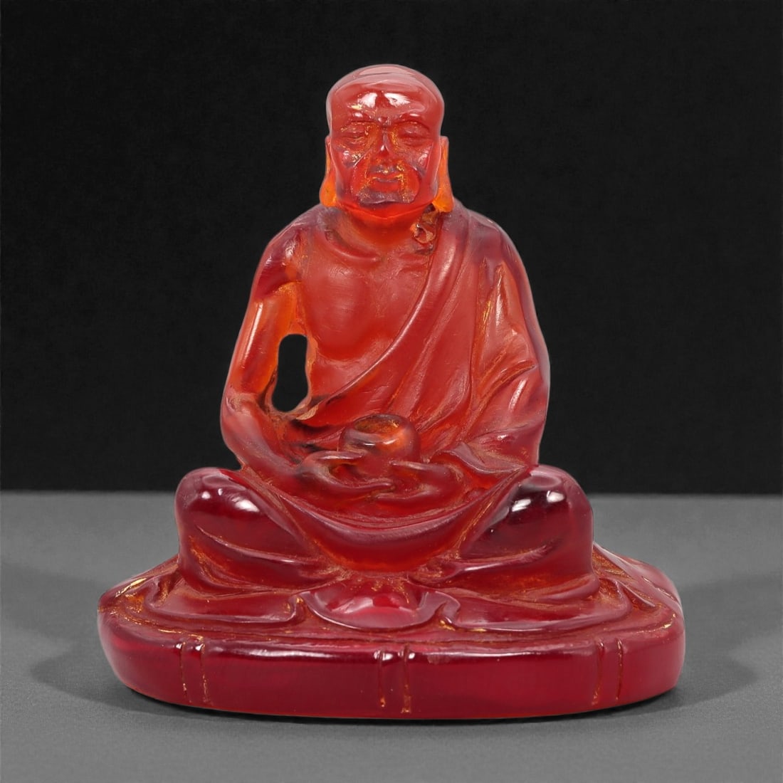 A Chinese Amber-Resin Figure of a Luohan, 20th Century, 38FH (1 of 2)