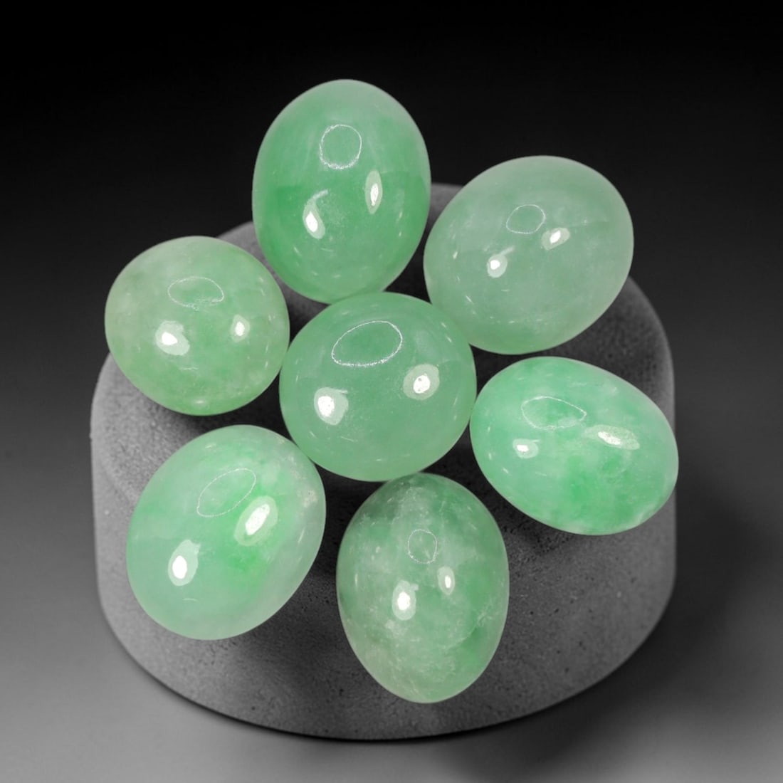 Natural Type A Jadeite Jade - Loose Cabochon Gemstone, 99AN: Crafted from natural Type A jadeite jade, these seven cabochons exhibit a translucent pale green hue with subtle tonal variations inherent to the material. Each stone is cut en cabochon with a smooth,