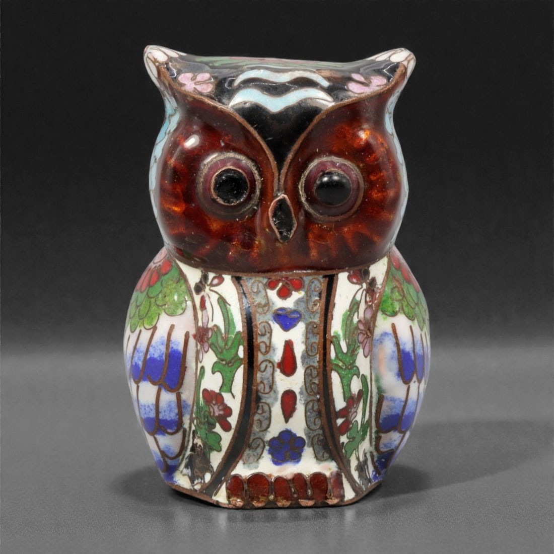 A Chinese Cloisonne Enamel Owl Effigy, 20th Century, 68YC: Constructed in copper and decorated with polychrome cloisonne enamel, the figure represents a standing owl with a rounded body and forward-facing posture. The head is prominently modeled with large ci
