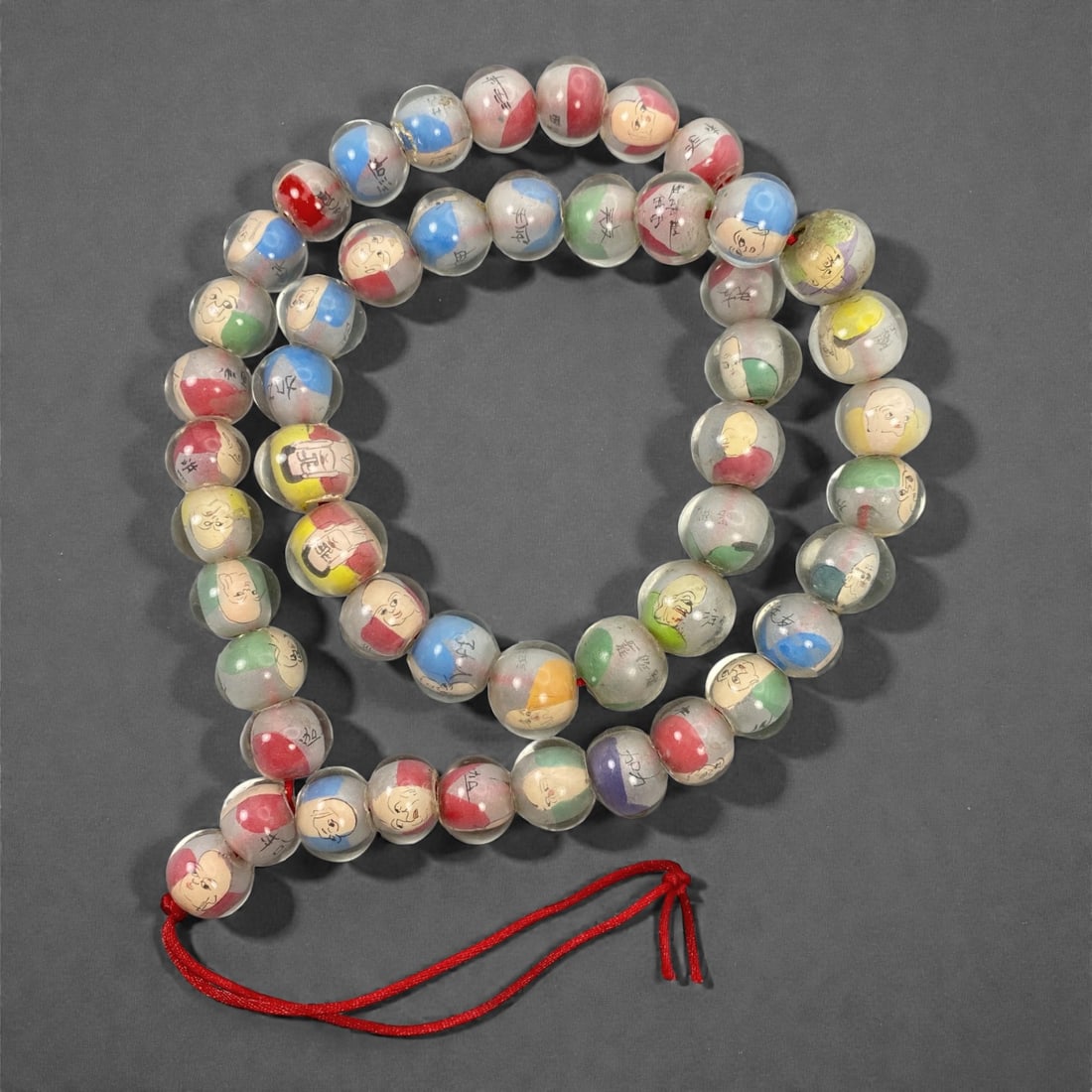 A Chinese Glass Beaded Necklace with Inner Painting, 20th Century, 36FJ: The necklace is formed as a long strand of spherical transparent glass beads, each meticulously decorated with inner-painted figural portraits and calligraphic characters executed in fine black line o
