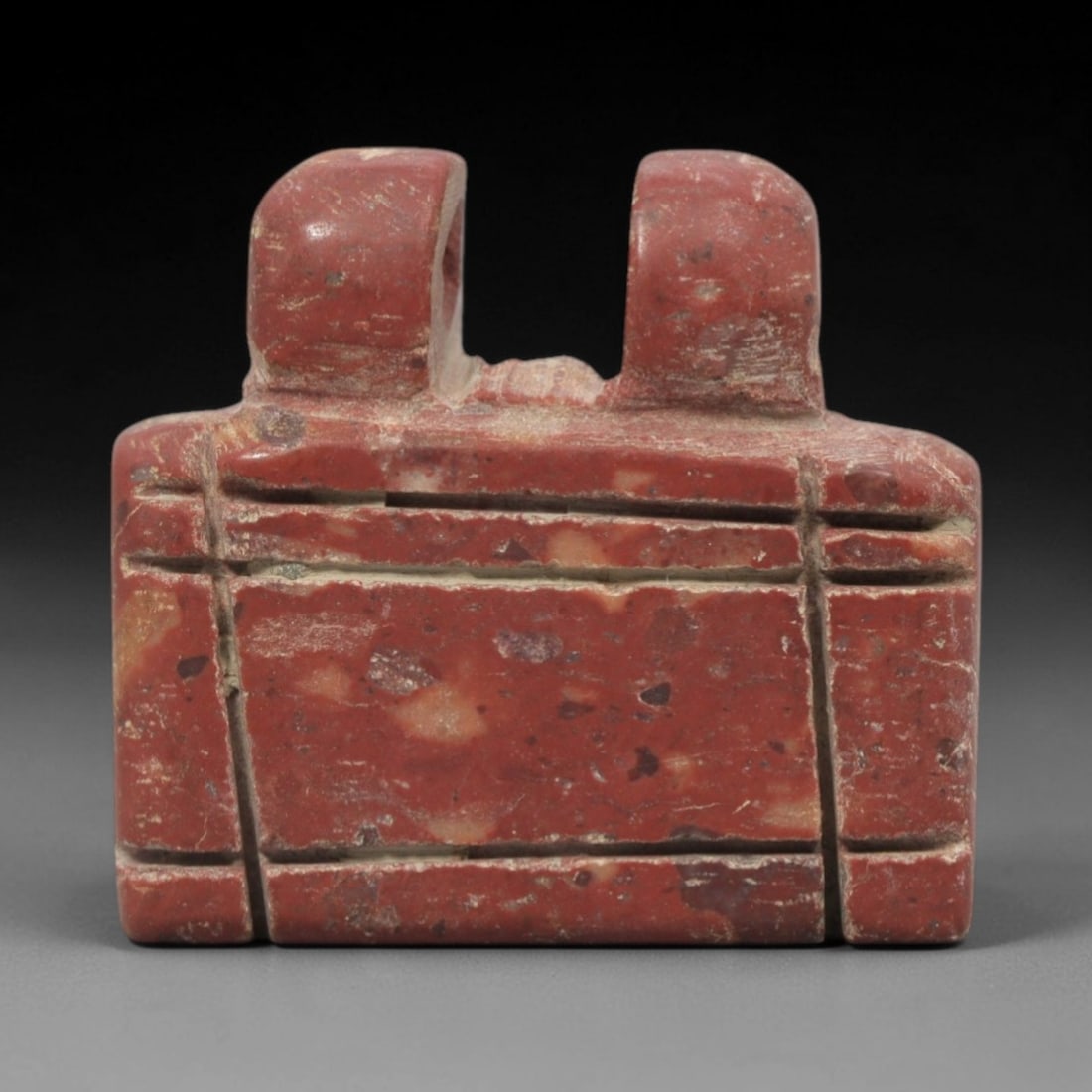 Ancient Near Eastern Red Stone Double Shrine Amulet - Carved Pendant Figure, 37ZV: This amulet is carved from a rich, variegated red stone with natural lighter veining, likely brecciated jasper or red steatite, featuring a distinctive double-shrine form. The piece boasts a symmetric