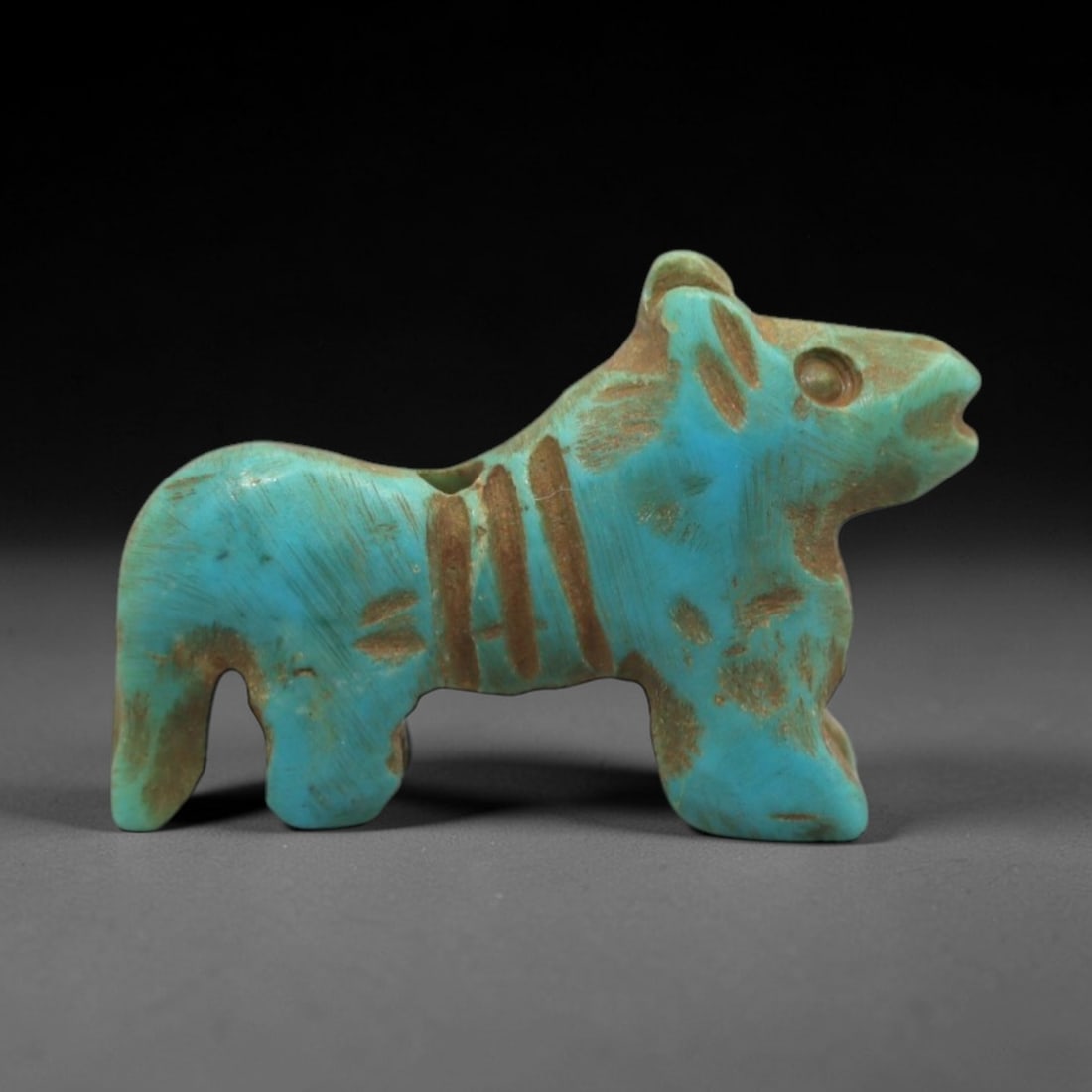 Ancient Turquoise Equine Amulet - Egyptian Animal Figurine, 11ZS: This artifact is a carved turquoise equine amulet, crafted in the stylized zoomorphic tradition of ancient Egypt. The amulet depicts a standing horse or donkey with simplified anatomical features, inc
