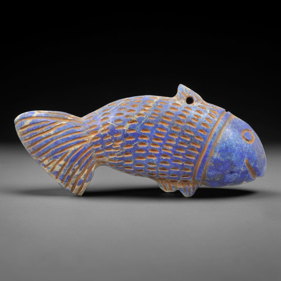 Near Eastern Lapis Lazuli Plaque - Tribal Art Fish Amulet Relief, 32ZA: Carved from solid lapis lazuli, this Near Eastern tribal art plaque is shaped as a stylized fish amulet, executed with detailed tribal craftsmanship. The fish form is rendered with incised scale motif