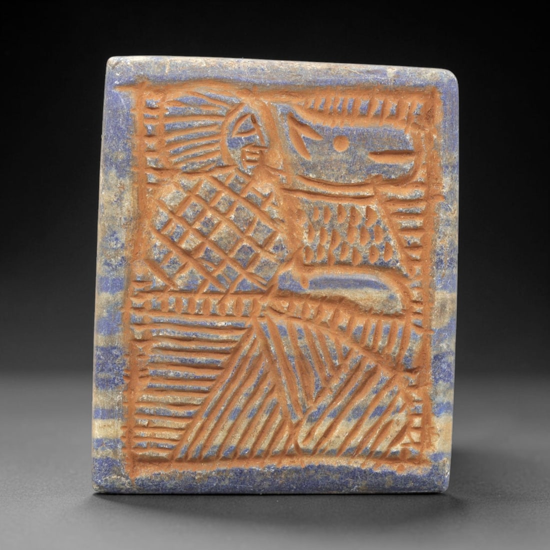 Near Eastern Lapis Lazuli Plaque - Tribal Art Figure & Animal Relief, 10ZA: Carved from natural lapis lazuli stone, this Near Eastern tribal art plaque relief features a hand-carved composition of a stylized human figure alongside an animal motif, executed with incised linear