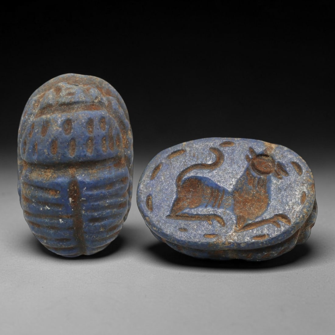 Ancient Lapis Lazuli Scarab - Near Eastern Zoomorphic Seal, 29XT: This artifact is hand-carved from lapis lazuli, employing traditional ancient lapidary techniques consistent with Near Eastern Bronze Age seal craftsmanship. The object takes the form of a scarab beet