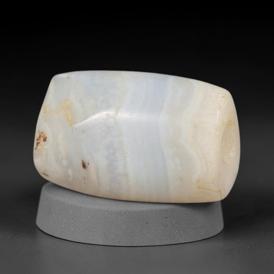 Ancient Agate Bead - Silk Road Miniature Cylinder Amulet, 22BD: Carved from banded agate, the bead features a smooth cylindrical barrel form with a polished surface that highlights the stone's natural wavy concentric banding, ranging from milky white and pale blue