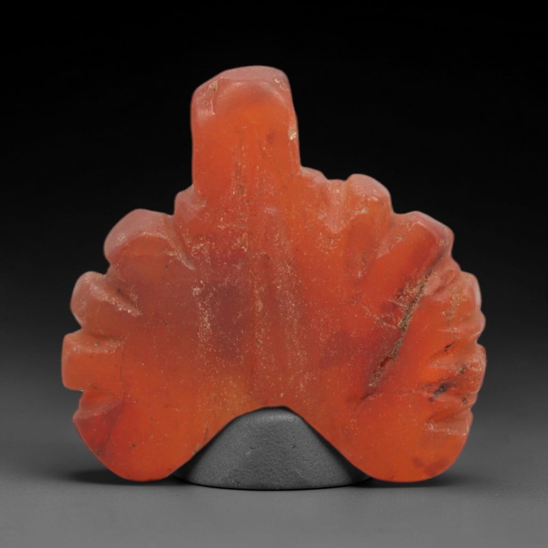 Ancient Carnelian Bird Amulet - Egyptian Figurine, 81XS: This amulet is carved from polished carnelian, exhibiting a rich, warm orange-red hue with natural surface patina and subtle mineral inclusions. The form depicts a stylized avian figure with a raised 