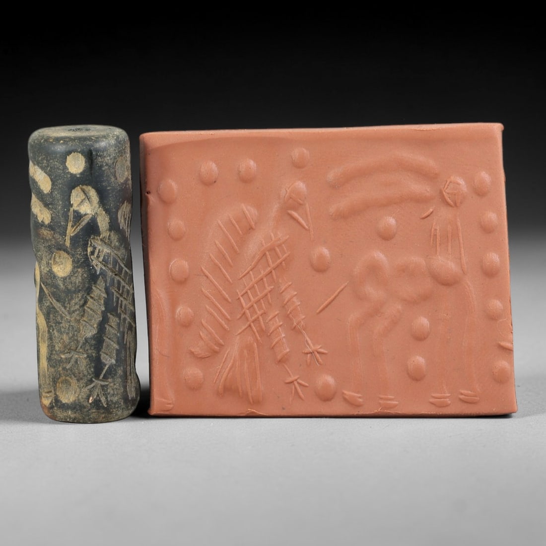 Ancient Serpentine Cylinder Seal - Mesopotamian Ibex & Vulture, 69FX: Carved from serpentine, this cylinder seal follows the classic cylindrical form of ancient Mesopotamian administrative and ritual artifacts. Its surface is intricately carved with a dynamic scene feat