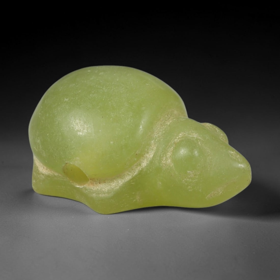 Ancient Serpentine Tortoise Amulet - Near Eastern Figurine, 83AR: This artifact is carved from pale, translucent green serpentine, exhibiting a smooth, polished surface with subtle natural inclusions and faint surface wear consistent with age. The form is a stylized