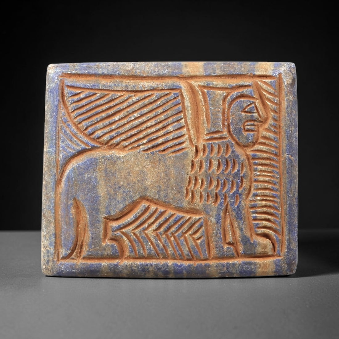 Near Eastern Lapis Lazuli Plaque - Tribal Art Figure & Feline Relief, 53BG: This Near Eastern tribal art plaque is carved from lapis lazuli, a semi-precious stone valued for its deep blue hue and suitability for intricate relief work. The rectangular plaque features a meticul