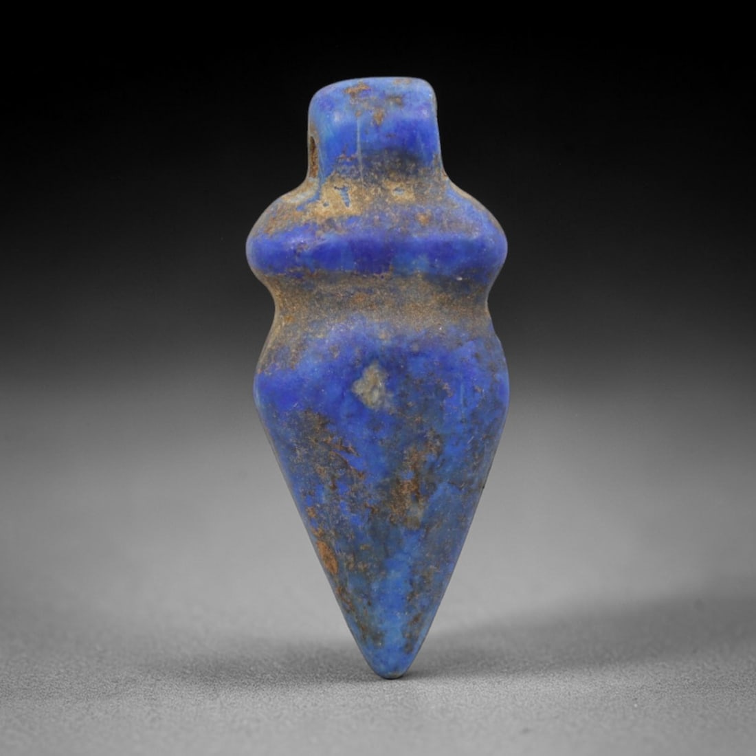 Ancient Lapis Lazuli Heart Amulet - Egyptian Ritual Pendant, 17ZT: Carved from lapis lazuli, this amulet is formed in a classic teardrop-heart shape, with a rounded upper lug pierced for suspension, its body defined by a subtle raised collar at the shoulder and taper