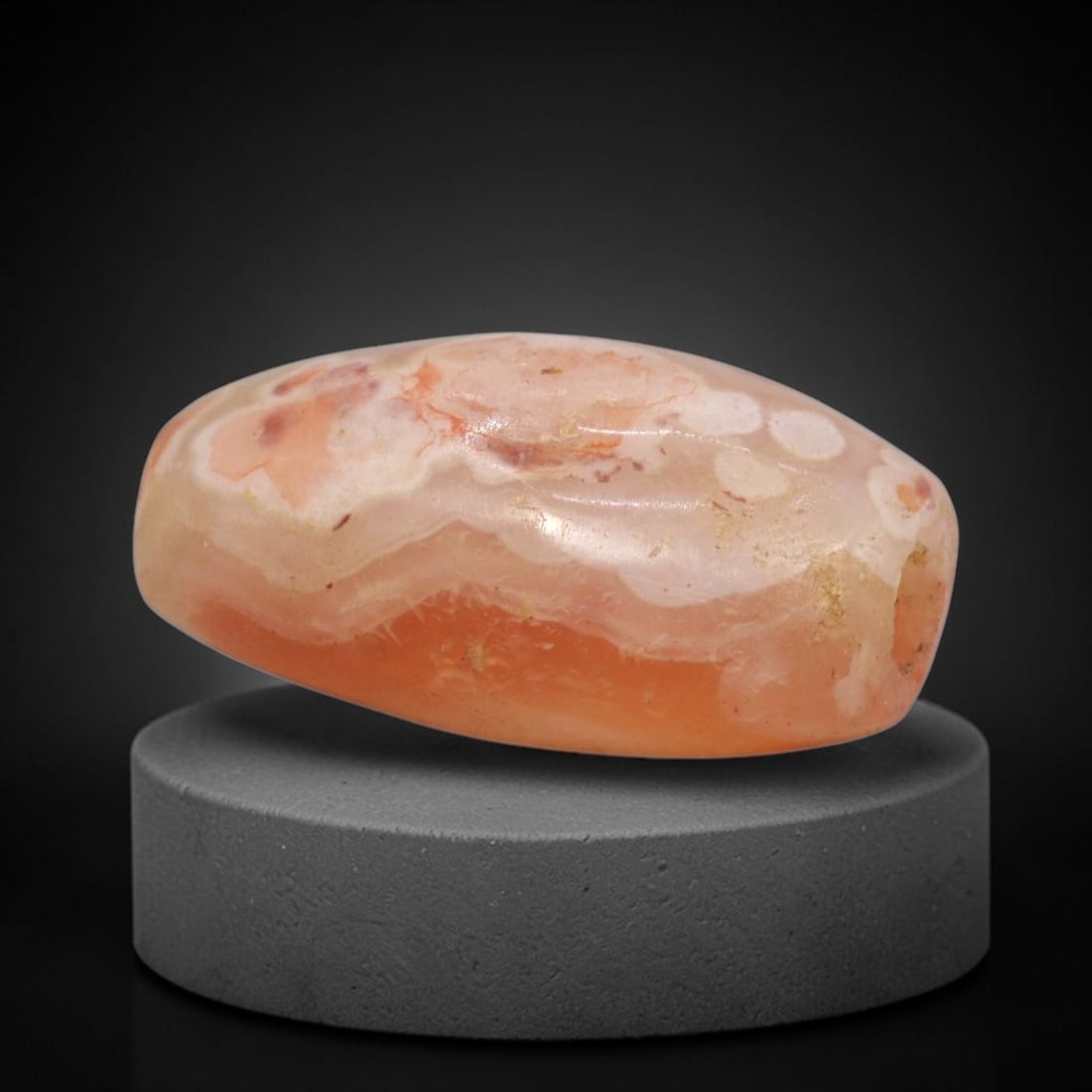 Ancient Agate Bead - Afghan Barrel Bead, 91XW: This bead is crafted from translucent peach-pink and creamy-white banded agate, shaped into a compact barrel form with a precisely drilled central suspension hole, characteristic of ancient Afghan lap