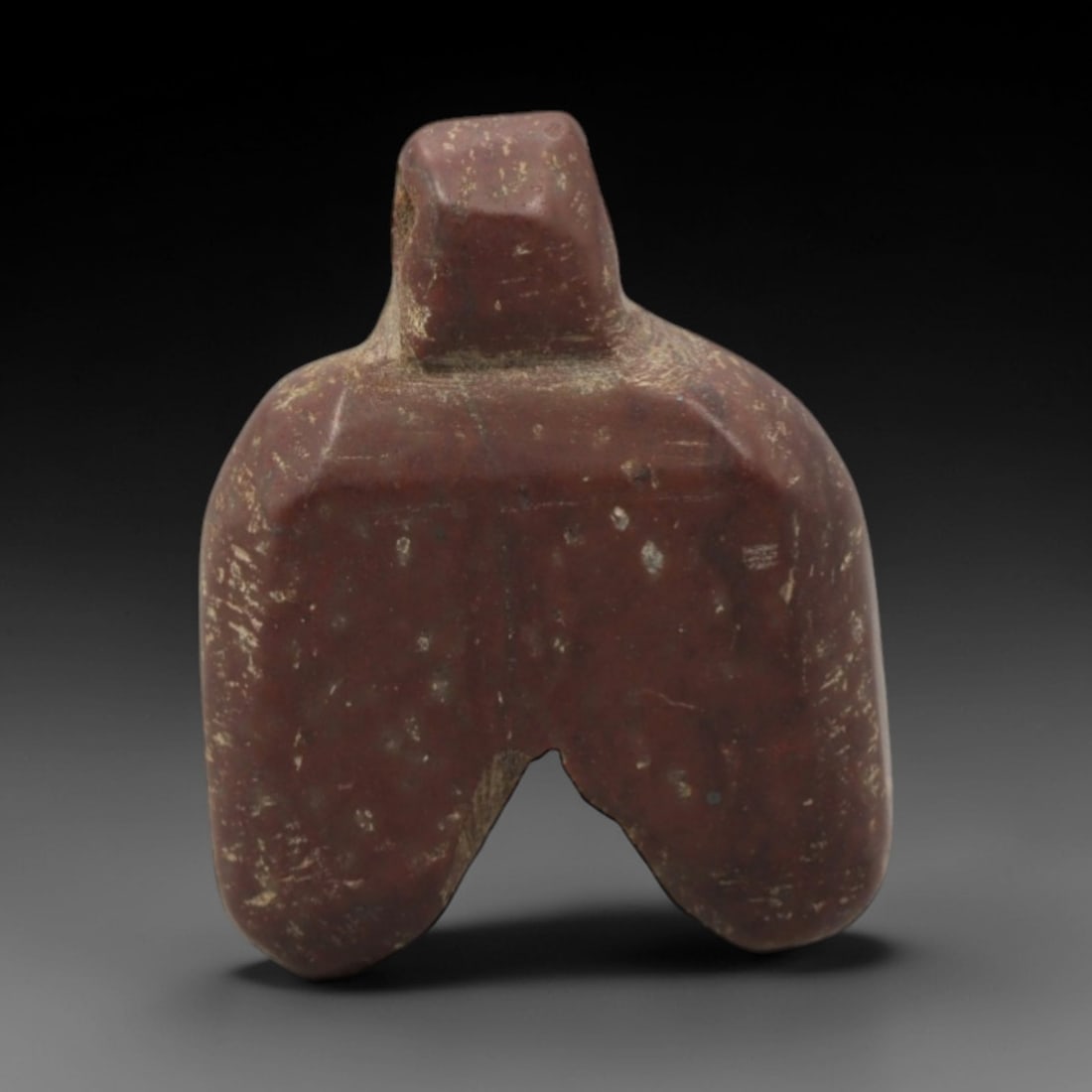 Ancient Stone Idol - Near Eastern Anthropomorphic Figurine, 36XR: Carved from deep reddish-brown stone, this miniature anthropomorphic idol features a stylized form with a squared top section, broad torso, and two thick, downward-extending legs. The simplified, geom