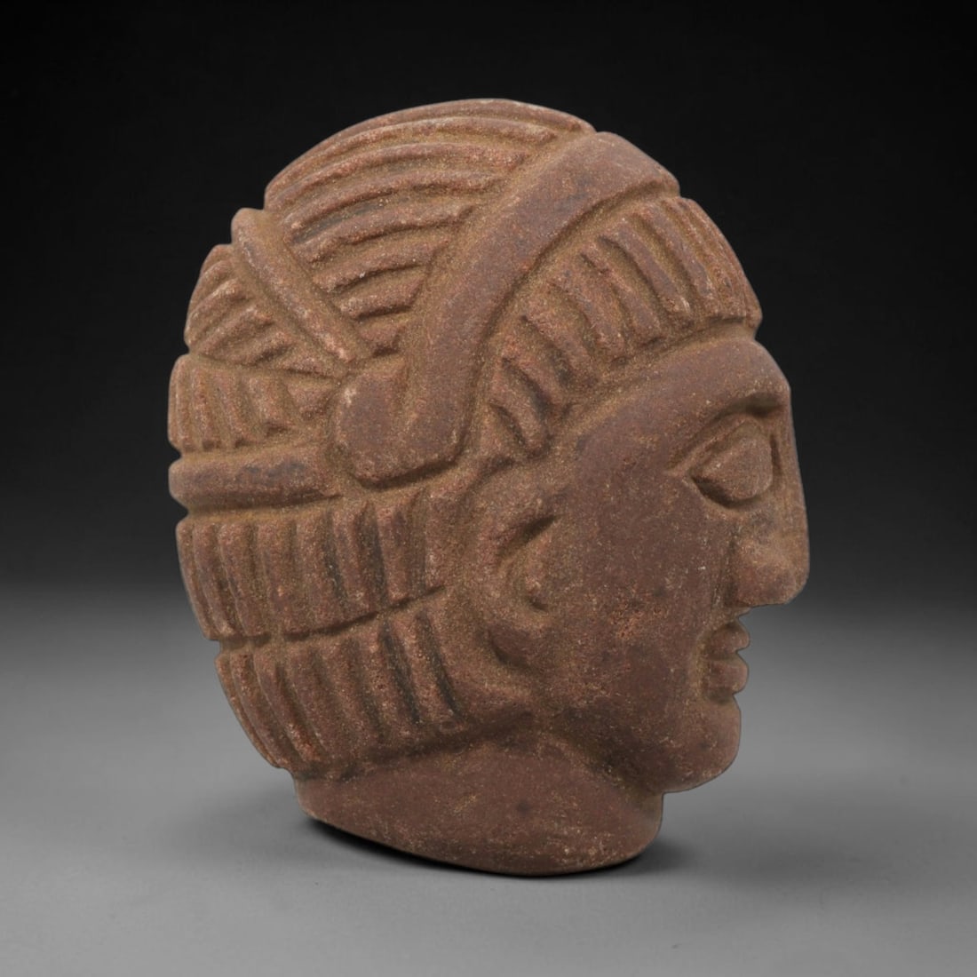 Ancient Stone Bust - Near Eastern Anthropomorphic Figurine, 11ZX: Carved from stone, the artifact is a three-dimensional human bust in profile, crafted in the ancient Near Eastern style. The surface bears incised details rendering a stylized headdress with layered,