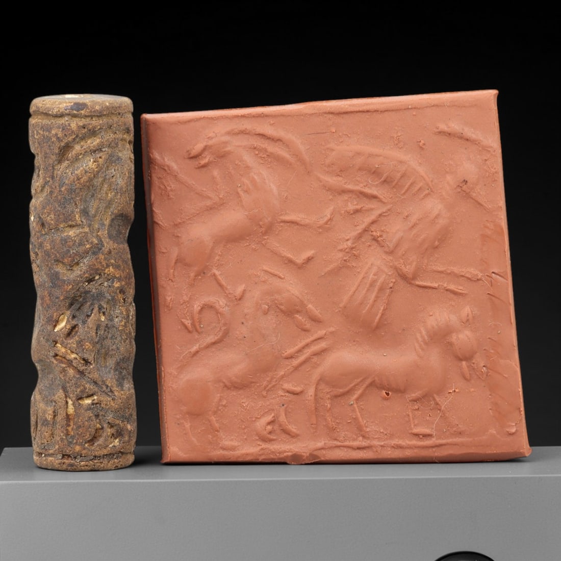 Ancient Steatite Cylinder Seal - Mesopotamian Animal Procession Scene, 70AN: Carved from dense steatite, this ancient Mesopotamian cylinder seal features a dynamic linear relief composition of a winged creature and multiple animal figures in procession, executed in the charact