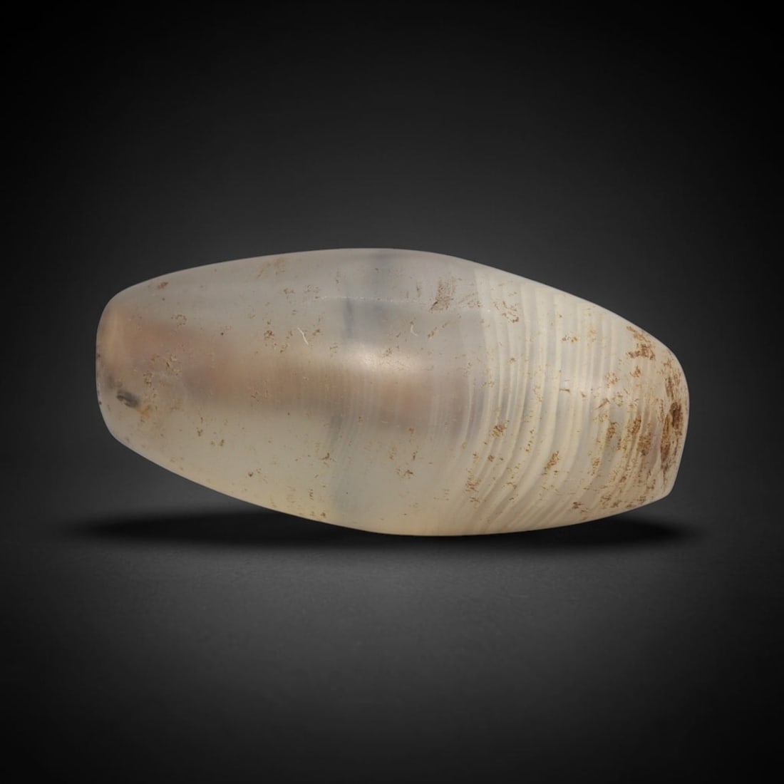 Ancient Agate Bead - Western Asiatic Amulet, 63XT: This bead is carved from translucent banded agate, exhibiting fine lapidary workmanship consistent with ancient bead-making traditions of Western Asiatic regions including Bactria and the Silk Road co