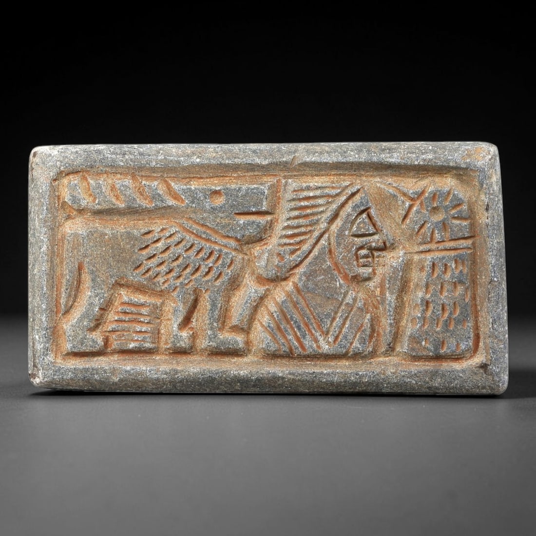 Near Eastern Schist Plaque - Tribal Art Figure & Animal Relief, 67BG: Carved from schist, this rectangular plaque features a relief composition of a stylized anthropomorphic figure positioned beside a quadruped animal, rendered with incised linear and decorative detaili