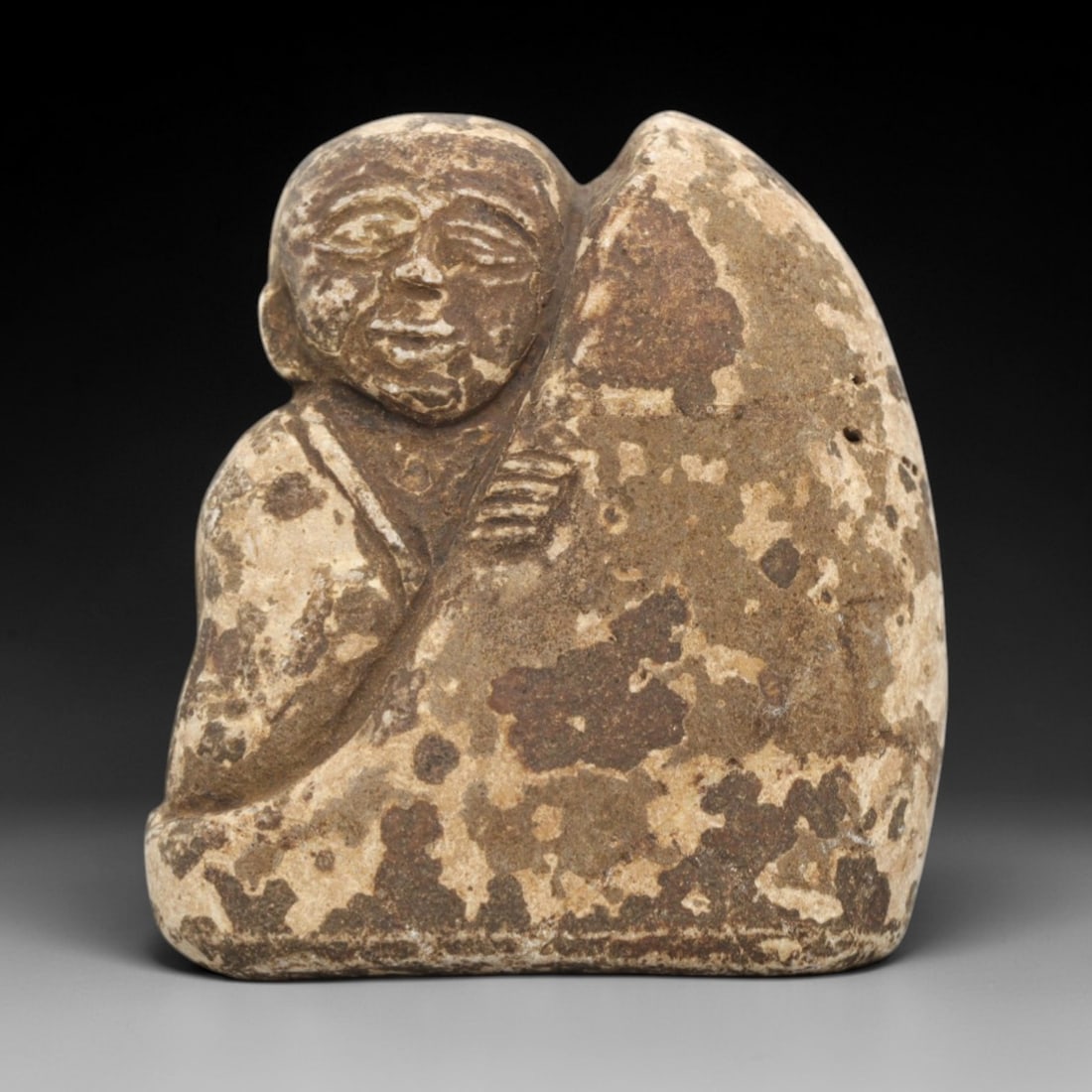 Edo Period Stone Monk - Japanese Antique Figurine, 78ZV: Carved from a weathered stone, this figurine depicts a seated Edo period Buddhist monk, with one hand resting on a large draped form, incised lines defining the flowing robes, serene facial features, 