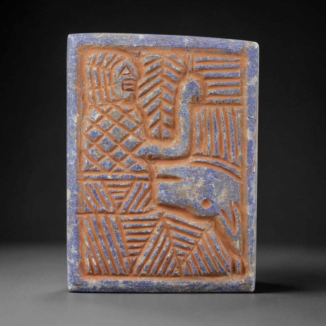 Near Eastern Lapis Lazuli Plaque - Tribal Art Figure & Animal Relief, 5BG: Carved from lapis lazuli, this rectangular plaque features a relief carving depicting a stylized human figure alongside an animal motif, executed in the linear, geometric style characteristic of Near