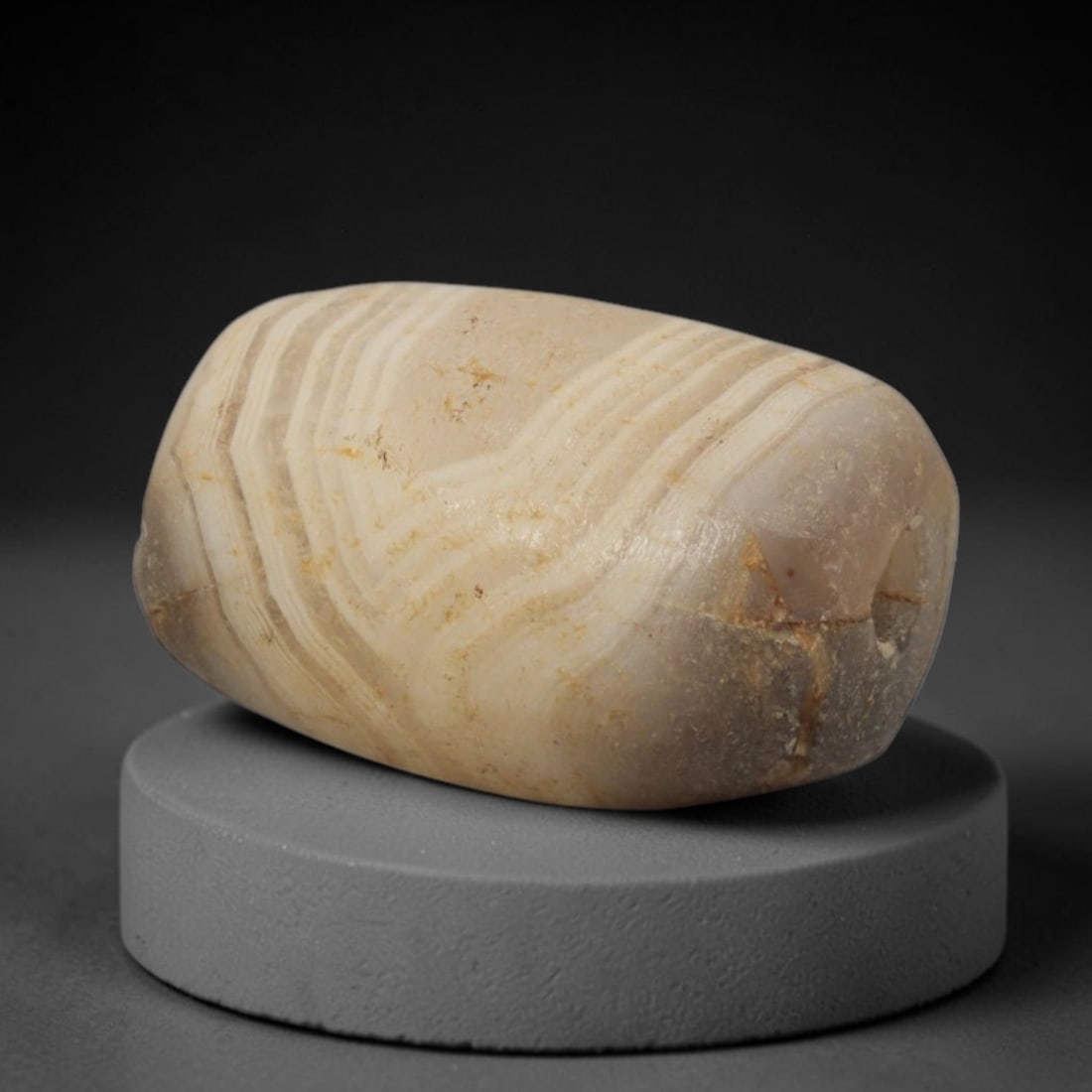 Ancient Banded Agate Bead - Western Asiatic Miniature Amulet, 46XW: This bead is expertly carved from delicately banded agate, showcasing refined lapidary craftsmanship consistent with ancient Western Asian (Bactrian or Indus Valley) bead-making traditions. The compac