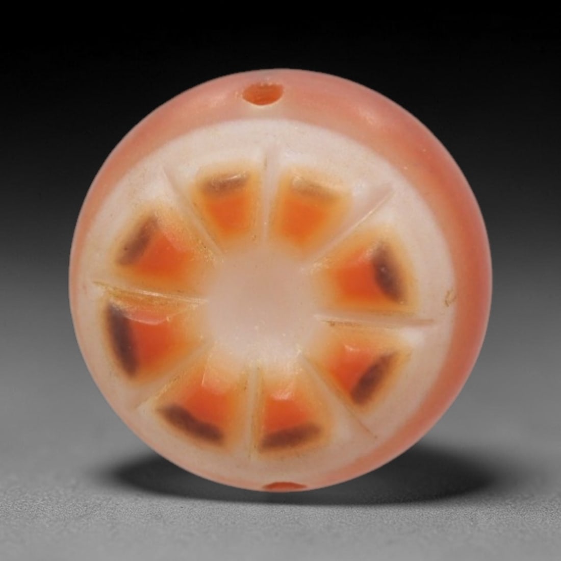 Antique Agate Citrus Slice Bead - Central Asian Nature-Inspired Pendant, 19ZW: Carved from banded agate with a soft peach-pink base and creamy white core, this bead features a symmetrical eight-segment citrus slice motif, with warm orange segments accented by subtle dark brown t