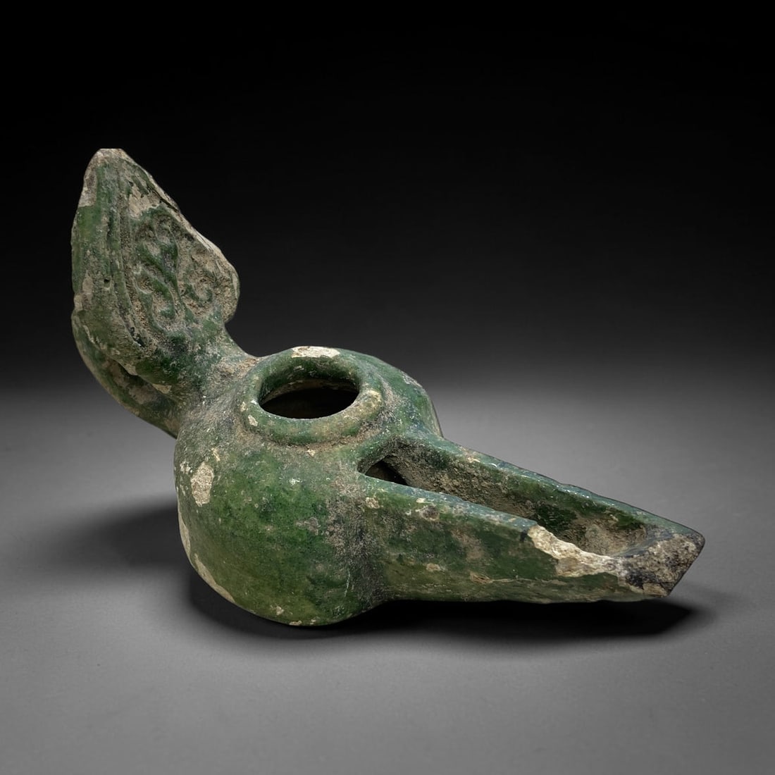 Ancient Seljuk Glazed Pottery Oil Lamp - Islamic, 164g, 41AA: Crafted from earthenware, this Seljuk-era oil lamp is coated in a vibrant green lead glaze with extensive weathering, patchy loss, and encrustation, revealing the underlying ceramic body. The form fea