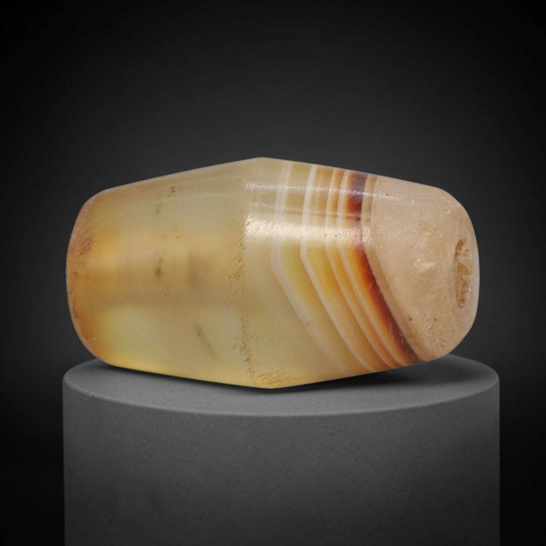 Ancient Banded Agate Bead - Western Asiatic Miniature Amulet, 40XW: This bead is expertly carved from richly banded translucent agate, showcasing masterful lapidary craftsmanship consistent with ancient Western Asian (Bactrian or Indus Valley) bead-making traditions.