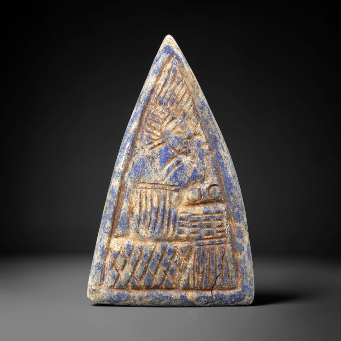 Near Eastern Lapis Lazuli Plaque - Tribal Art Figure Relief, 66BG: This Near Eastern tribal art plaque is carved from lapis lazuli, a semi-precious stone valued for its deep blue hue and suitability for detailed relief work. The triangular plaque features a meticulou