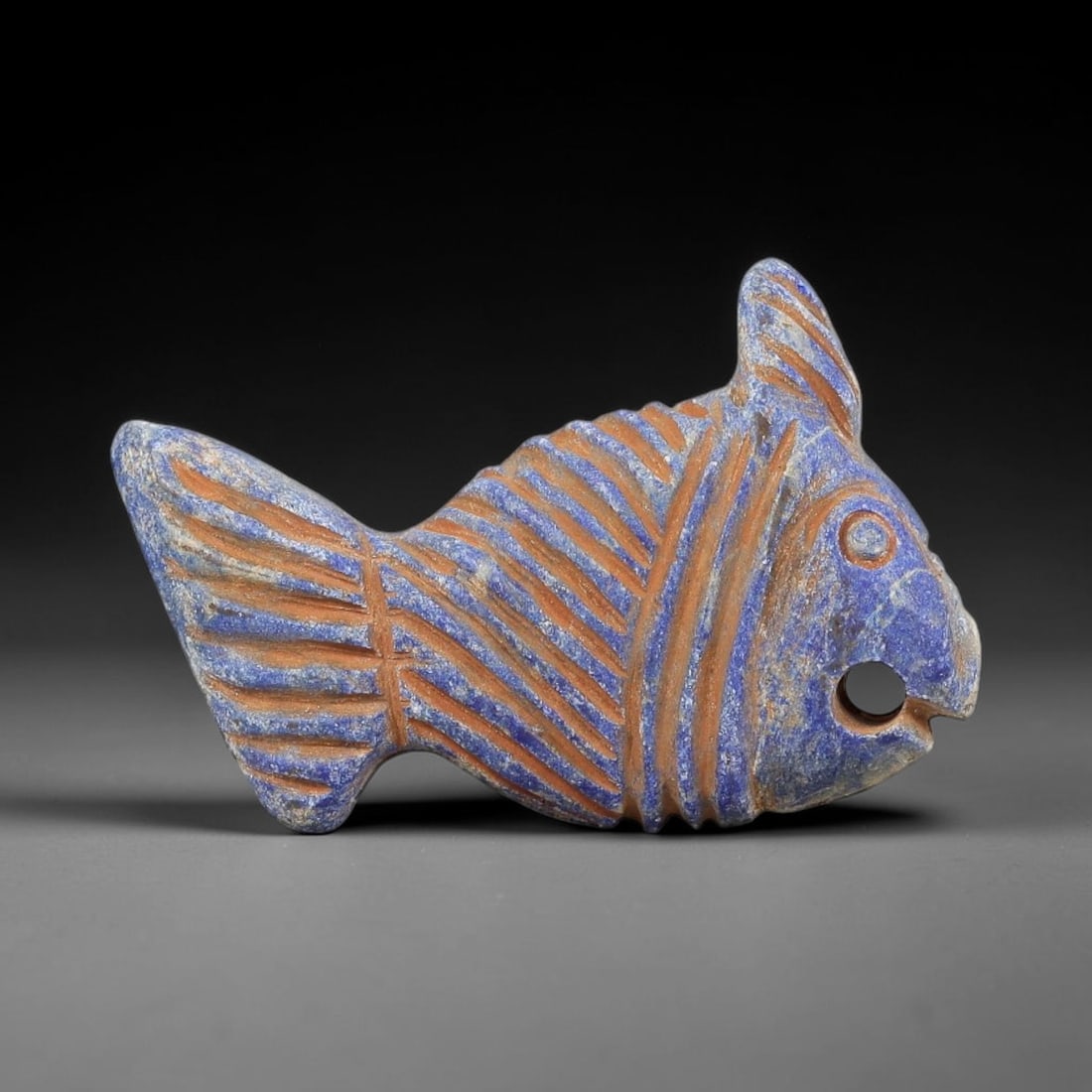 Near Eastern Lapis Lazuli Plaque - Tribal Art Fish Amulet Figurine, 60BF: Carved from solid lapis lazuli, this Near Eastern tribal art piece is shaped as a stylized fish amulet figurine, executed with detailed tribal craftsmanship. The fish form is rendered with incised dia