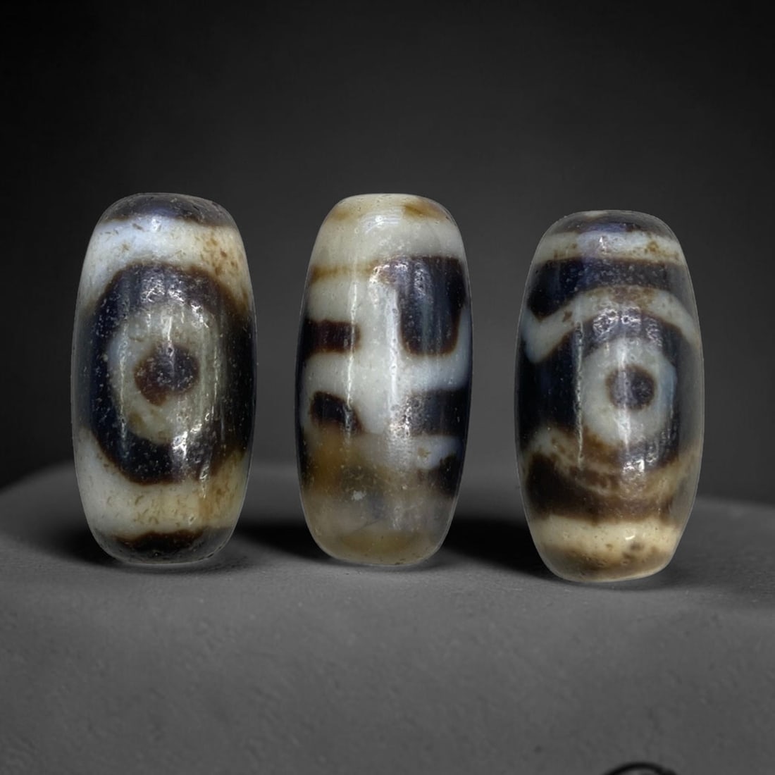 Chinese Dzi Agate Beads - Old Spiritual Beads, 9g, 93AA: This set of three old Chinese dzi beads is crafted from natural agate stone, with a combined weight of 9 grams and each bead measuring 2 cm in height. The beads feature classic circular and geometric 