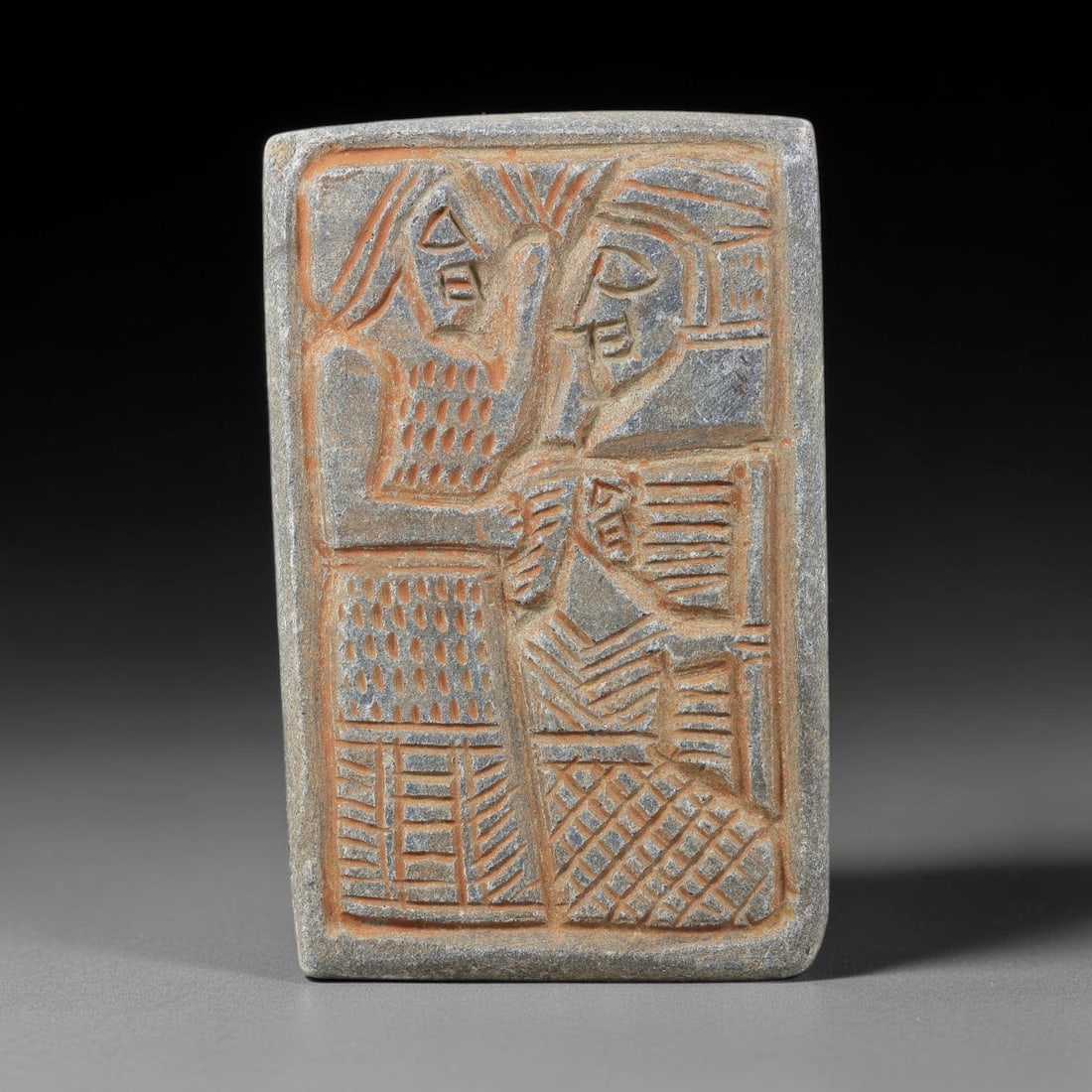 Near Eastern Schist Plaque - Tribal Art Two Figure Relief, 15BG: This Near Eastern tribal art plaque is carved from schist, a fine-grained metamorphic stone ideal for detailed relief work. The rectangular plaque features a stylized relief composition, with precise