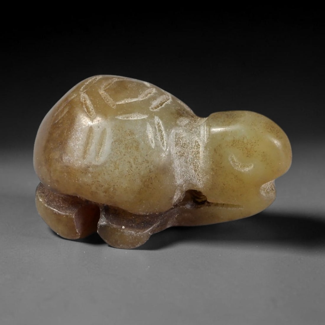 Antique Qing Jade Tortoise Amulet - Chinese Miniature Figurine, 82AS: Carved from a soft, pale greenish-brown jade with natural inclusions and a smooth, aged patina, this miniature tortoise amulet features incised linear detailing on the shell to define scute patterns,